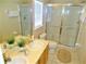 Bright bathroom featuring a double sink vanity, tiled floors, glass shower, and a separate toilet area at 2281 Royal Ridge Dr, Davenport, FL 33896