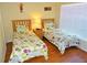 Cozy bedroom featuring two twin beds with colorful floral bedding and a tiki bar sign at 2281 Royal Ridge Dr, Davenport, FL 33896