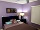 Inviting bedroom with purple walls, a modern bed, and stylish decor accents at 2281 Royal Ridge Dr, Davenport, FL 33896