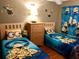 Cozy bedroom featuring twin beds with Minion themed bedding and decor for a fun, playful atmosphere at 2281 Royal Ridge Dr, Davenport, FL 33896