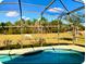 Screened-in pool with views of horses grazing in a fenced-in pasture, offering a serene outdoor setting at 2281 Royal Ridge Dr, Davenport, FL 33896