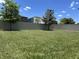 Large backyard with healthy lawn, defined by a modern, light-colored fence at 2436 Gratia Pl, Casselberry, FL 32707