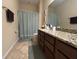Bathroom featuring shower/tub combination, brown cabinets, and granite countertop at 2436 Gratia Pl, Casselberry, FL 32707