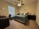 Bedroom featuring a queen bed, study space, and neutral colors at 2436 Gratia Pl, Casselberry, FL 32707