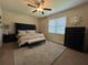 Cozy bedroom with tufted headboard, ceiling fan, and ample natural light at 2436 Gratia Pl, Casselberry, FL 32707