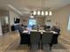 Bright dining area with modern lighting fixture and view to the living room at 2436 Gratia Pl, Casselberry, FL 32707