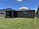 Home's rear exterior shows the screened-in porch and well-maintained backyard at 2436 Gratia Pl, Casselberry, FL 32707