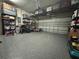 Wide garage with overhead storage racks and gray epoxy flooring at 2436 Gratia Pl, Casselberry, FL 32707