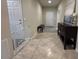 Hallway entrance has a dark bench, side table, and tile flooring at 2436 Gratia Pl, Casselberry, FL 32707