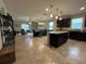 Open-concept kitchen with granite island and dark wood cabinets, perfect for entertaining at 2436 Gratia Pl, Casselberry, FL 32707