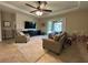 Spacious living room featuring tile floors, a ceiling fan, a TV and a sliding glass door at 2436 Gratia Pl, Casselberry, FL 32707