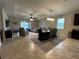 Open-concept living room with tile flooring, ceiling fan, and sliding glass doors to the backyard at 2436 Gratia Pl, Casselberry, FL 32707