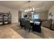 Open-concept living room with tile flooring, ceiling fan, and views of the kitchen and backyard at 2436 Gratia Pl, Casselberry, FL 32707