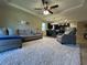 Spacious living room with plush carpeting, ceiling fan, and an open floor plan at 2436 Gratia Pl, Casselberry, FL 32707