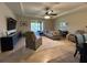 Spacious living room featuring tile floors, a ceiling fan, a TV and a sliding glass door at 2436 Gratia Pl, Casselberry, FL 32707