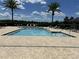 Community pool with tiled pool deck and lounge chairs at 2436 Gratia Pl, Casselberry, FL 32707
