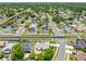 Expansive aerial view of a residential neighborhood with lush green trees and community lakes on a sunny day at 2637 Debany Rd, Kissimmee, FL 34744