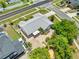 An aerial view of a well-maintained home featuring a brick driveway, screened-in porch, and lush landscaping in a desirable neighborhood at 2637 Debany Rd, Kissimmee, FL 34744