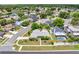 Aerial view showcases the home's well-maintained lawn, landscaping and backyard pool in a quiet neighborhood at 2637 Debany Rd, Kissimmee, FL 34744