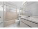 This bathroom features a tub-shower combination, a toilet, and a sink with a large mirror at 2637 Debany Rd, Kissimmee, FL 34744