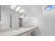 Bathroom with dual sinks, large mirror, and natural light from skylight at 2637 Debany Rd, Kissimmee, FL 34744