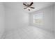 This bedroom features white tile floors, a ceiling fan, and a window with blinds at 2637 Debany Rd, Kissimmee, FL 34744