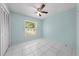 Bedroom with bright-blue walls features a large window and tile floors at 2637 Debany Rd, Kissimmee, FL 34744