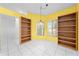 Sunny dining room with tile floors and open shelving flanking two bright windows at 2637 Debany Rd, Kissimmee, FL 34744