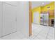 Bright entryway featuring tile floors and access to kitchen with stainless refrigerator at 2637 Debany Rd, Kissimmee, FL 34744
