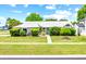 Charming single-story home featuring lush landscaping and a well-manicured lawn at 2637 Debany Rd, Kissimmee, FL 34744
