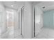 Hallway featuring white tile floors with access to bathroom, bedrooms, and a closet at 2637 Debany Rd, Kissimmee, FL 34744