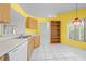 Kitchen featuring white countertops, tile floors, and yellow walls at 2637 Debany Rd, Kissimmee, FL 34744
