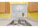 A kitchen sink and pass through into the living area creates an open concept space at 2637 Debany Rd, Kissimmee, FL 34744