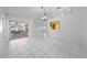 Spacious living room with tile floors that lead to a screened patio with furniture at 2637 Debany Rd, Kissimmee, FL 34744