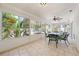 This sunroom features tile floors, windows, and a ceiling fan with an outdoor view at 2637 Debany Rd, Kissimmee, FL 34744