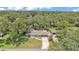 Spacious property featuring a single-Gathering home, mature trees, and a large lawn from an aerial view at 2727 Easton Ter, Lakeland, FL 33803