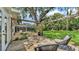 Relaxing backyard deck with wood pergola, outdoor chairs, lush lawn, and a glimpse of the screened-in lanai at 2727 Easton Ter, Lakeland, FL 33803