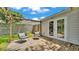 Inviting backyard deck with two outdoor chairs, complemented by double doors leading into the home at 2727 Easton Ter, Lakeland, FL 33803