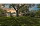 Large backyard with mature trees, a well-kept lawn, screened-in lanai, and relaxing backyard deck at 2727 Easton Ter, Lakeland, FL 33803