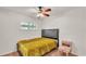 Bedroom featuring a simple bed frame and a golden yellow comforter at 2727 Easton Ter, Lakeland, FL 33803
