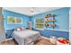 A charming bedroom with blue walls, a comfortable bed, and sunny window views at 2727 Easton Ter, Lakeland, FL 33803