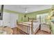 Bedroom featuring a wooden bed frame, light green walls, and wood floors at 2727 Easton Ter, Lakeland, FL 33803