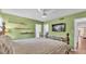 Bedroom featuring a wooden bed frame, light green walls, and wood floors at 2727 Easton Ter, Lakeland, FL 33803