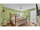 Bedroom featuring a wooden bed frame, light green walls, and wood floors at 2727 Easton Ter, Lakeland, FL 33803