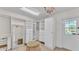 Spacious walk-in closet with custom shelving, drawers, a large mirror, and a chandelier at 2727 Easton Ter, Lakeland, FL 33803
