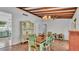 Dining room featuring a wood beam ceiling, wood floors, and vintage furniture at 2727 Easton Ter, Lakeland, FL 33803