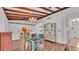 Charming dining room with wood floors, beam ceiling, and adjacent laundry room and kitchen at 2727 Easton Ter, Lakeland, FL 33803