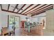 Dining room featuring wood beam ceiling, wood floors, and a sliding door to the backyard at 2727 Easton Ter, Lakeland, FL 33803