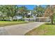 Charming single-story home with a large driveway and a lush green lawn at 2727 Easton Ter, Lakeland, FL 33803