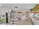 Spacious kitchen featuring tile flooring, green cabinets, butcher block counters, and stainless steel appliances at 2727 Easton Ter, Lakeland, FL 33803